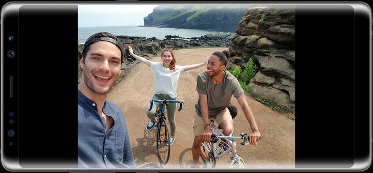 Photo taken by Galaxy Note8?s front camera of three people riding their bikes on a dirt road